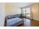 Cozy bedroom featuring wood floors, a large window with blinds, and a desk area at 1836 N Crystal Lake Dr # 46, Lakeland, FL 33801