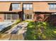 Exterior view of the two-story home with lush lawn, brick accents, and bright garage at 1836 N Crystal Lake Dr # 46, Lakeland, FL 33801
