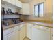 Well-lit kitchen featuring white cabinets and a stainless steel sink at 1836 N Crystal Lake Dr # 46, Lakeland, FL 33801