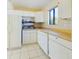 Bright kitchen with white appliances, tiled flooring, and ample counter space at 1836 N Crystal Lake Dr # 46, Lakeland, FL 33801