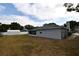 Spacious backyard featuring a well-kept exterior, a storage shed, and a screened-in patio at 2556 Roslyn Ln, Lakeland, FL 33812