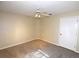 A cozy bedroom with neutral carpet, ceiling fan, and white door at 2556 Roslyn Ln, Lakeland, FL 33812