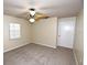 Bedroom with neutral walls, carpet, ceiling fan, and a single door for privacy at 2556 Roslyn Ln, Lakeland, FL 33812