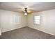 This is a bedroom with carpet, ceiling fan, and two windows at 2556 Roslyn Ln, Lakeland, FL 33812