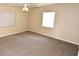 Bright bedroom with neutral carpet, ceiling fan, and natural light from two windows at 2556 Roslyn Ln, Lakeland, FL 33812