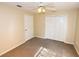 Neutral carpeted bedroom with closet and ceiling fan at 2556 Roslyn Ln, Lakeland, FL 33812
