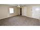 Spacious bedroom with neutral carpeting, ceiling fan and a window providing natural light at 2556 Roslyn Ln, Lakeland, FL 33812