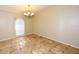 A dining room features tile floors, a hanging chandelier, and window with blinds at 2556 Roslyn Ln, Lakeland, FL 33812