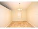 Open dining area with tiled flooring, a chandelier and large windows for natural lighting at 2556 Roslyn Ln, Lakeland, FL 33812