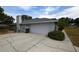 Exterior featuring a two-car garage and long driveway at 2556 Roslyn Ln, Lakeland, FL 33812