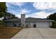 Attached two-car garage and landscaped yard provides convenience and curb appeal at 2556 Roslyn Ln, Lakeland, FL 33812