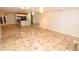 Open-concept living area with tile floors, a view of the kitchen, and stylish breakfast bar seating at 2556 Roslyn Ln, Lakeland, FL 33812