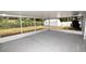 Spacious screened patio with concrete flooring, white frame, and backyard views at 2556 Roslyn Ln, Lakeland, FL 33812