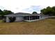 Back of house features a screened-in patio, perfect for outdoor relaxation at 2556 Roslyn Ln, Lakeland, FL 33812