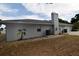 View of exterior featuring a chimney, a/c unit and a garage at 2556 Roslyn Ln, Lakeland, FL 33812