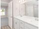 Modern bathroom with a double vanity and a large mirror at 3166 Laurel Oak Ln, Winter Haven, FL 33884