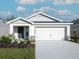 Charming single-story home with a two-car garage and well-maintained landscaping at 3166 Laurel Oak Ln, Winter Haven, FL 33884