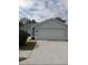 Light blue one-story house with a two-car garage at 4197 Cannes Ave, Lake Wales, FL 33859