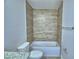 A clean and well-lit bathroom with wood-look tile in the shower at 4712 Grandview Glen Dr, Auburndale, FL 33823
