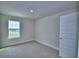 Carpeted bedroom featuring a window view of the neighborhood at 4712 Grandview Glen Dr, Auburndale, FL 33823
