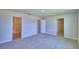 Unfurnished bedroom with carpet, bathroom and walk in closet entrances at 4712 Grandview Glen Dr, Auburndale, FL 33823