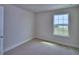 Carpeted bedroom featuring a window view of the neighborhood at 4712 Grandview Glen Dr, Auburndale, FL 33823