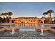 Inviting community pool with water features, surrounded by palm trees and a clubhouse at 4712 Grandview Glen Dr, Auburndale, FL 33823