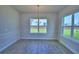 Light-filled dining room boasts elegant molding, wood-look tile floor, and contemporary chandelier at 4712 Grandview Glen Dr, Auburndale, FL 33823