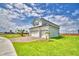 Exterior view of a two-story home with a three-car garage, a palm tree, and a well-maintained lawn at 4712 Grandview Glen Dr, Auburndale, FL 33823