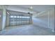 Spacious garage featuring a garage door and concrete flooring at 4712 Grandview Glen Dr, Auburndale, FL 33823