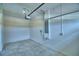 Spacious garage featuring a garage door and concrete flooring at 4712 Grandview Glen Dr, Auburndale, FL 33823