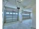 Spacious three car garage with overhead doors and automatic door openers with concrete flooring at 4712 Grandview Glen Dr, Auburndale, FL 33823