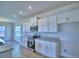 Bright kitchen features stainless steel appliances, granite countertops, and white cabinets at 4712 Grandview Glen Dr, Auburndale, FL 33823