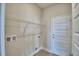 Practical laundry room with wire shelving and utility connections near the back door at 4712 Grandview Glen Dr, Auburndale, FL 33823