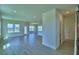 Open-concept living room featuring tile flooring and multiple windows providing ample natural light at 4712 Grandview Glen Dr, Auburndale, FL 33823