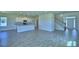 Spacious open-concept living area featuring a modern kitchen with stainless steel appliances and a staircase at 4712 Grandview Glen Dr, Auburndale, FL 33823
