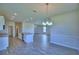 Open living space with a modern kitchen island, recessed lighting, and decorative wall paneling at 4712 Grandview Glen Dr, Auburndale, FL 33823