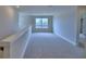 Spacious carpeted loft offers a versatile living area with plenty of natural light at 4712 Grandview Glen Dr, Auburndale, FL 33823