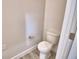 Simple powder room featuring a toilet and neutral-colored walls and flooring at 4712 Grandview Glen Dr, Auburndale, FL 33823