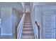 Carpeted staircase features white railing and stained wood banister at 4712 Grandview Glen Dr, Auburndale, FL 33823