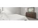 Bedroom with plush carpet and an attractive dresser with a decorative mirror at 5335 Se 127Th Ln, Belleview, FL 34420