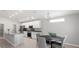 Modern kitchen with white cabinets, stainless steel appliances, granite countertops, and an adjacent dining area at 5335 Se 127Th Ln, Belleview, FL 34420
