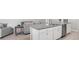 Close-up of a kitchen island featuring white cabinets, stainless steel appliances, and granite countertops at 5335 Se 127Th Ln, Belleview, FL 34420