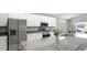 Bright kitchen with stainless steel appliances, granite countertops, and sleek white cabinetry at 5335 Se 127Th Ln, Belleview, FL 34420