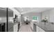 Modern kitchen with stainless steel appliances, granite countertops, and an adjacent dining area at 5335 Se 127Th Ln, Belleview, FL 34420