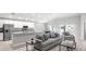 Spacious open-concept area with a stylish living room that flows into a modern kitchen and dining space at 5335 Se 127Th Ln, Belleview, FL 34420