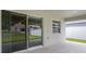 Covered patio overlooking a backyard with white fence at 5335 Se 127Th Ln, Belleview, FL 34420