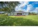 Spacious backyard featuring a deck and generous green lawn perfect for outdoor entertainment and relaxation at 6155 Bethlehem Rd, Mulberry, FL 33860