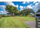 Expansive backyard featuring a verdant lawn and mature trees, providing ample space for outdoor activities and play at 6155 Bethlehem Rd, Mulberry, FL 33860