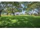 Extensive backyard with mature trees, a lush lawn, and a play area, ideal for outdoor enjoyment at 6155 Bethlehem Rd, Mulberry, FL 33860